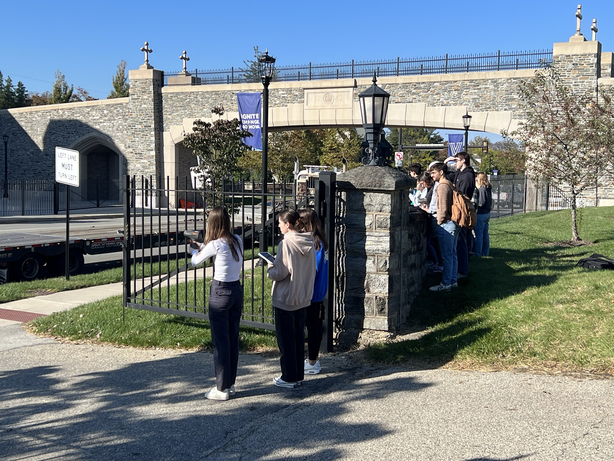 Students conducting a field study near Villanova's campus gateway